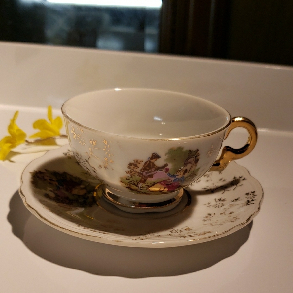 Elegant Gold and White Ceramic Teacup and Saucer Set